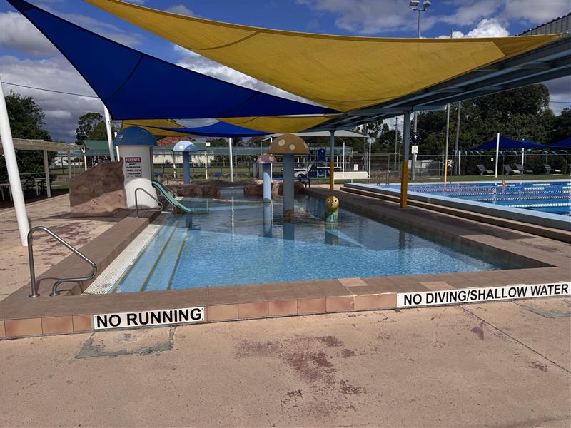 Outdoor, shaded children's splash pad.